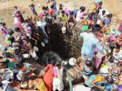 Impact of the Water Crisis: Villagers throw containers attached to ropes into a well to collect their daily supply of potable water after a tanker made its daily delivery at Shahapur, Maharashtra.